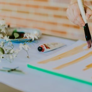 Freelance textile designer at a desk painting and creating stripes for a repeating design